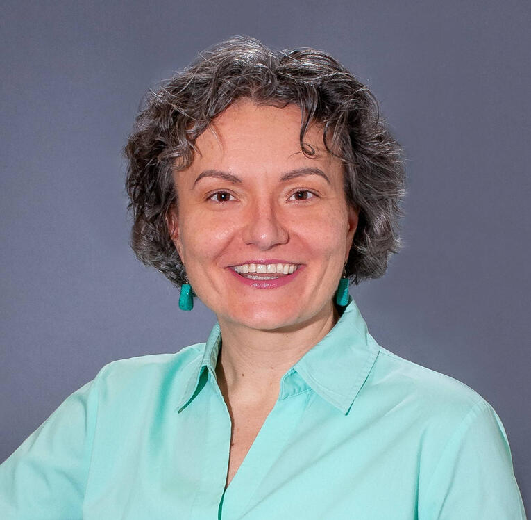 The image depicts Mariya Foley Mediator looking straight at you with a soft friendly smile.